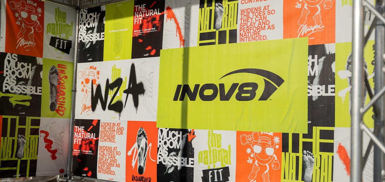 The INOV8 booth wall with bold poster graphics