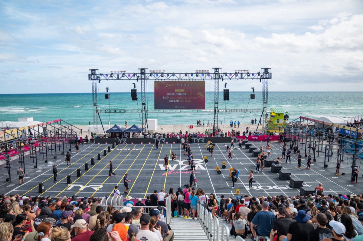 Packed stands and the stage rig at the Wodapalooza beach arena, ocean behind